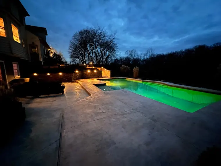 Rectangular pool and paver surround at dusk