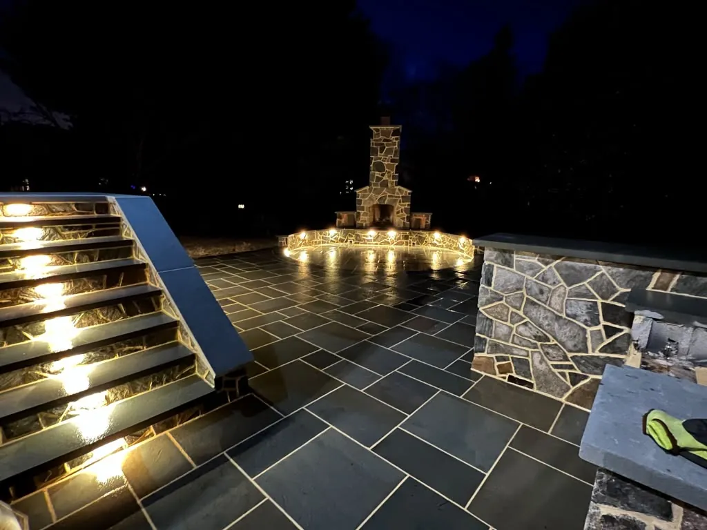 Wide stone staircase with built in lighting at night
